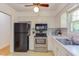 Bright kitchen with white cabinets, modern appliances, and a sink with natural light at 4300 Edgehill Ct, Raleigh, NC 27612