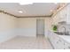 Bright kitchen featuring tile flooring, white cabinetry, and plenty of counter space and natural light at 4300 Edgehill Ct, Raleigh, NC 27612