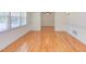 Sunlit living room featuring gleaming hardwood floors, with windows and a classic, neutral color palette at 4300 Edgehill Ct, Raleigh, NC 27612