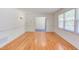 Bright living area with hardwood floors, showcasing neutral walls and ample natural light from a large window at 4300 Edgehill Ct, Raleigh, NC 27612