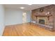 Comfortable living room featuring a brick fireplace and access to the kitchen at 4300 Edgehill Ct, Raleigh, NC 27612