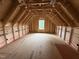 Spacious attic featuring a window and natural light at 5021 Mitchell Town Rd, Youngsville, NC 27596