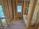 Unfinished bathroom showing wood framing, a window, and a tub during the construction phase at 5021 Mitchell Town Rd, Youngsville, NC 27596