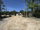 View of a home under construction, showing the bare lot ready for landscaping surrounded by lush trees at 5021 Mitchell Town Rd, Youngsville, NC 27596