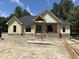 New construction home showing siding, brick foundation, and porch with stone steps to front door at 5021 Mitchell Town Rd, Youngsville, NC 27596