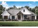 Charming white farmhouse featuring a beautiful porch, shingled roof, and professionally landscaped front yard at 5021 Mitchell Town Rd, Youngsville, NC 27596