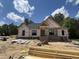 New construction home featuring brick foundation, framed windows, and a partially shingled roof ready for customization at 5021 Mitchell Town Rd, Youngsville, NC 27596