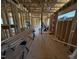 An expansive interior view showing the framing progress of a new construction home with visible stud walls at 5021 Mitchell Town Rd, Youngsville, NC 27596
