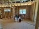 A bright interior framing view displaying window placement and room layout in a new construction home at 5021 Mitchell Town Rd, Youngsville, NC 27596