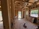 The interior framing with wall studs and window openings in a home under construction at 5021 Mitchell Town Rd, Youngsville, NC 27596
