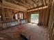 A bright interior framing view of a new home under construction, featuring large window openings at 5021 Mitchell Town Rd, Youngsville, NC 27596