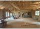 Large living room featuring wood framing, large windows, and open space at 5021 Mitchell Town Rd, Youngsville, NC 27596