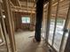 View of framed living room with a window, studs, and subfloor, highlighting the space's potential and natural light at 5021 Mitchell Town Rd, Youngsville, NC 27596