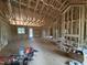 Spacious living room featuring exposed framing and natural light at 5021 Mitchell Town Rd, Youngsville, NC 27596