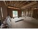 Newly framed room featuring windows that provide lots of natural light at 5021 Mitchell Town Rd, Youngsville, NC 27596
