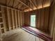 Newly framed room with a window providing plenty of natural light at 5021 Mitchell Town Rd, Youngsville, NC 27596