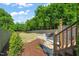 Spacious backyard with stone patio, fire pit, and lush landscaping, offering a perfect outdoor oasis at 512 Montague Ln, Raleigh, NC 27601