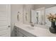 This bathroom features a large mirror and white marble counter with gray cabinets at 512 Montague Ln, Raleigh, NC 27601