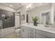 Modern bathroom with dual sink vanity, decorative mirror, and sleek tile shower, creating a spa-like retreat at 512 Montague Ln, Raleigh, NC 27601