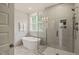 Modern bathroom with a glass-enclosed shower, freestanding tub, and sleek gray tile at 512 Montague Ln, Raleigh, NC 27601
