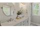 Bright bathroom featuring double sinks with marble countertops and round framed mirrors at 512 Montague Ln, Raleigh, NC 27601