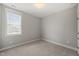 The carpeted bedroom features gray walls, white trim, and a window with blinds at 512 Montague Ln, Raleigh, NC 27601