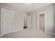 This empty bedroom is well lit with three doors leading to different spaces at 512 Montague Ln, Raleigh, NC 27601