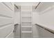 Walk in closet with painted white walls and dark wooden rods at 512 Montague Ln, Raleigh, NC 27601