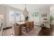 Elegant dining room with stylish chandelier and natural light from shuttered windows at 512 Montague Ln, Raleigh, NC 27601