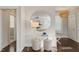 Bright foyer with a large circular mirror, clear acrylic console table, and hardwood floors at 512 Montague Ln, Raleigh, NC 27601