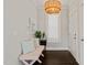 Bright foyer with stylish lighting, a cozy bench, and elegant dark hardwood floors at 512 Montague Ln, Raleigh, NC 27601