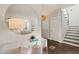 Inviting foyer with dark hardwood floors, a staircase, and a decorative round mirror at 512 Montague Ln, Raleigh, NC 27601