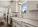 Close up of the white farmhouse sink and countertops, highlighting the natural light at 512 Montague Ln, Raleigh, NC 27601