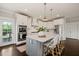 Bright kitchen features a large island, stainless steel appliances, and white cabinetry at 512 Montague Ln, Raleigh, NC 27601