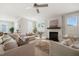 Bright living room featuring a fireplace, stylish seating, and abundant natural light at 512 Montague Ln, Raleigh, NC 27601
