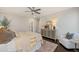 Comfortable main bedroom featuring a ceiling fan, sitting area, and a stylish dresser at 512 Montague Ln, Raleigh, NC 27601