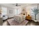 Inviting main bedroom with a ceiling fan, warm-toned bedding, and natural light from several windows at 512 Montague Ln, Raleigh, NC 27601