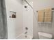 The white tiled shower includes a shampoo nook and modern shower head at 512 Montague Ln, Raleigh, NC 27601