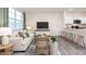 Bright and airy living room with a comfortable sofa and a view of the kitchen at 517 Fife Ct, Gibsonville, NC 27249