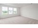 Sunlit bedroom showcasing plush carpet and picturesque neighborhood views at 525 Lochalsh Dr, Gibsonville, NC 27249