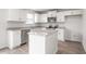 Bright eat-in kitchen with granite counters, stainless appliances, white cabinetry, and an island at 525 Lochalsh Dr, Gibsonville, NC 27249