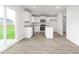 Eat-in kitchen with white cabinets, stainless appliances, granite counters, and backyard access at 525 Lochalsh Dr, Gibsonville, NC 27249