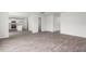 View of the open floorplan with gray LVP flooring and white paint connecting the kitchen and bathroom at 525 Lochalsh Dr, Gibsonville, NC 27249