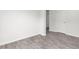 Minimalist room with modern wood-look floors, white walls, and a white door at 525 Lochalsh Dr, Gibsonville, NC 27249