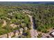 High angle aerial view of a neighborhood with mature trees and winding roads, highlighting community at 5600 Bennettwood Ct, Raleigh, NC 27612