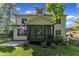 Backyard view of the home with a screened porch, and lush landscaping at 5600 Bennettwood Ct, Raleigh, NC 27612