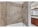Bathtub featuring tile surround, an adjustable shower head, and shampoo nook at 5600 Bennettwood Ct, Raleigh, NC 27612