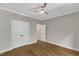 This bedroom includes hardwood floors, a ceiling fan, and a closet at 5600 Bennettwood Ct, Raleigh, NC 27612