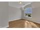 Well-lit room with a window view and hardwood floors at 5600 Bennettwood Ct, Raleigh, NC 27612