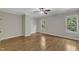 This bedroom features two windows, hardwood floors, neutral paint, and a ceiling fan at 5600 Bennettwood Ct, Raleigh, NC 27612